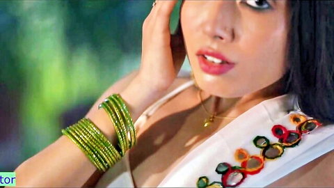 Seductive Indian beauty in green bangles and embroidered top pouting lips teasingly