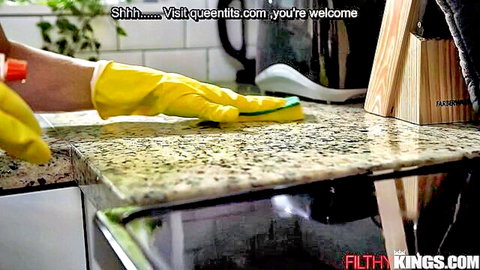 Yellow gloved hand scrubbing kitchen counter with green sponge in sexy cleaning tease