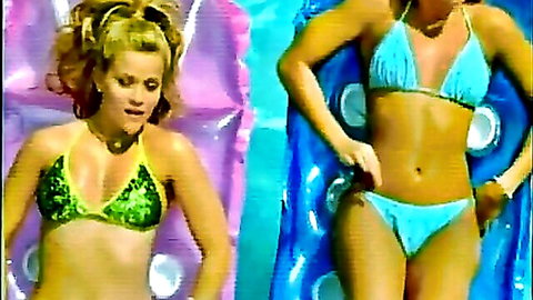 Two busty blondes in skimpy green and blue bikinis tease huge tits on pool floats