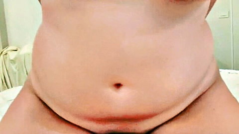 Curvy step sister displaying pregnant belly in nude close-up