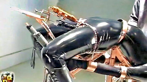 Claire arched back in black latex bondage restraints