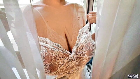 Busty LilyKoti in sheer white lace lingerie teasing deep cleavage