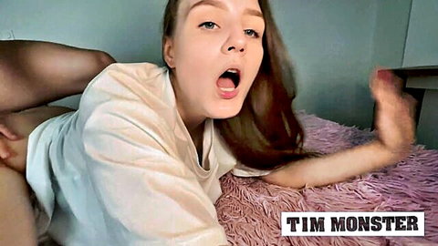 Redhead amateur in white tee and black stockings, open mouth pose on bed