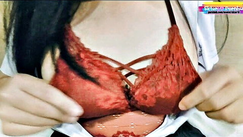 Thai woman in red lace bra exposing perky breasts tease