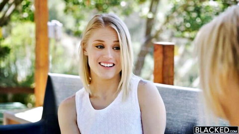 Ash Hollywood and Kate England, two smiling blondes in white tops outdoors