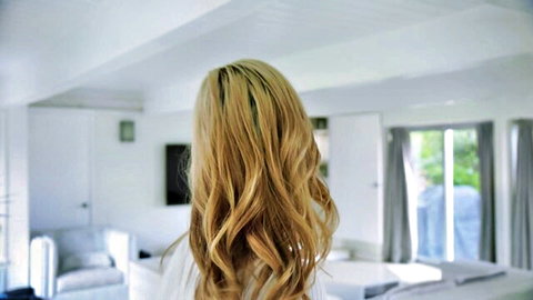 Mazzy Grace blonde model in white top, teasing back view