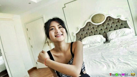Kyu Thai beauty smiling seductively in black top on bed, amateur tease