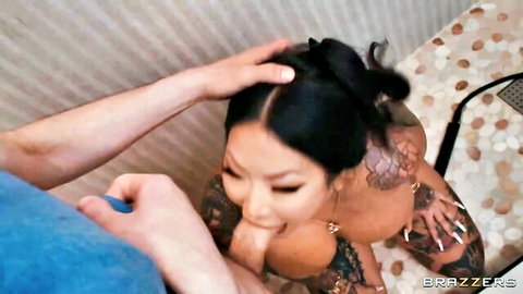 Tattooed Asian babe grips thick cock with hand in shower ready for blowjob