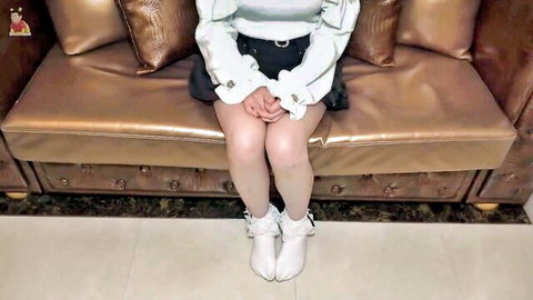 Cute Asian girl in short skirt and white stockings sitting seductively