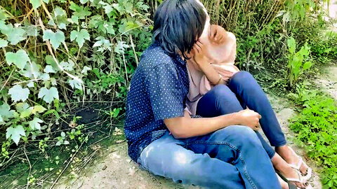 Hijab woman passionately kissed on neck by boyfriend outdoors