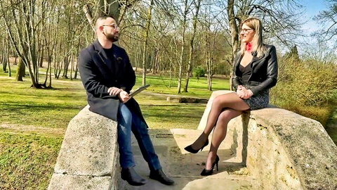 Red Lily, 33yo French blonde in leather jacket, skirt, stockings on outdoor stone bridge chat