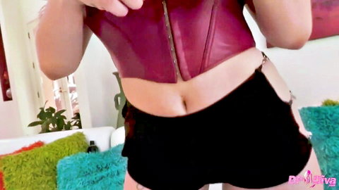 Lindsay Lee in red leather corset and black strappy shorts, seductive tease