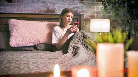 Blonde teen Melody Marks texting seductively on bed in white tee