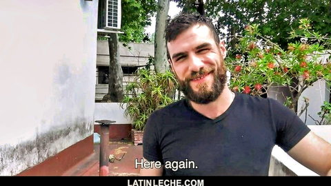Bearded Latino man smiling in black t-shirt, outdoor Latin Leche teaser