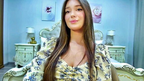 ViolettaCosmo in low-cut floral dress, smiling webcam tease