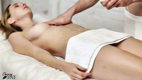 Cherry Grace topless during sensual massage, hand on breasts