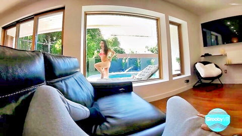 Trans model Ember Fiera in pink bikini, teasing poolside pose