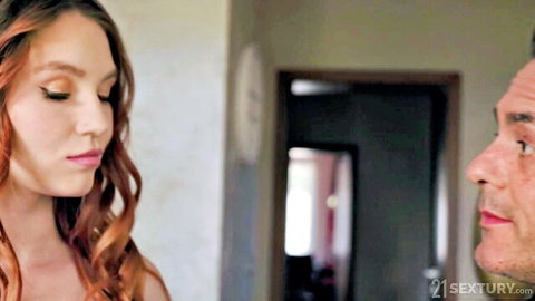 Redhead beauty stares seductively at handsome man in intimate close-up foreplay tease