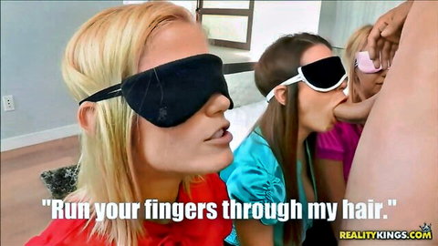 Blindfolded blonde babe kissed on cheek by brunette in sexy lesbian tease with hand in hair
