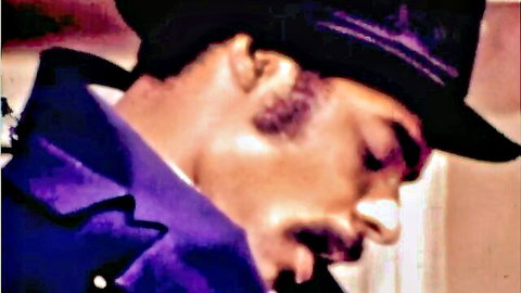 Vintage XXX thumbnail: suited Black man in purple jacket and hat, side profile close-up