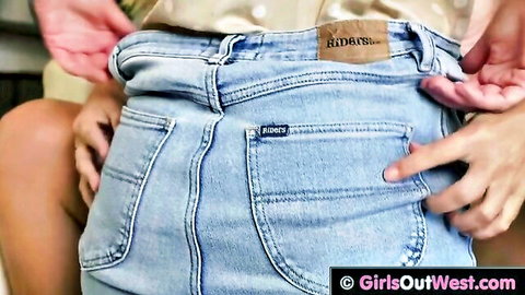 Hands pulling down tight blue jeans exposing woman's bare ass crack from behind