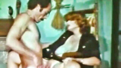 Vintage redhead woman with exposed breasts in explicit couple sex scene