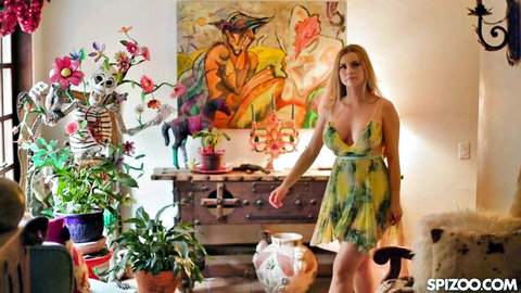 Busty blonde Jessie Rogers in low-cut green dress teasing indoors