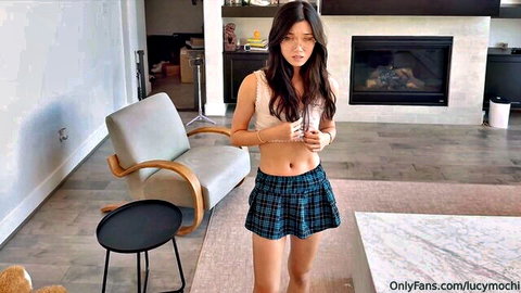 Petite Asian teen in tiny plaid schoolgirl skirt and crop top teasing midriff in living room