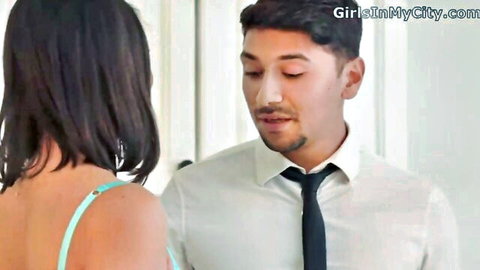 Brunette in green lingerie strap faces suited Asian man in intimate close-up flirt