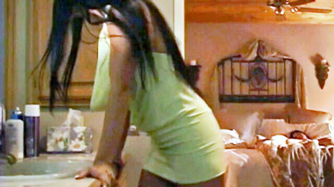 Curvy brunette MILF with big tits topless bending over bathroom sink exposing her hanging breasts