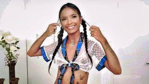 Tattooed Asian teen in sheer schoolgirl uniform smiling playfully with pigtails