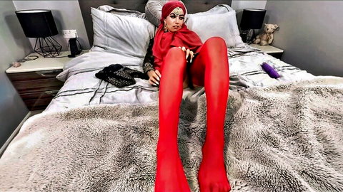 Curvy Arab woman in red hijab spreads legs in red stockings teasing with purple dildo