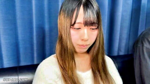 Cute Asian teen with bangs and long hair in white sweater teasing closeup