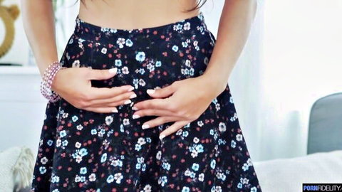 Apolonia Lapiedra in floral skirt, teasing pose with hands on hips