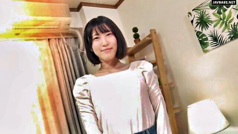 Smiling Japanese woman with short black hair in white puffy blouse and jeans