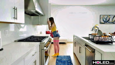 Ava Marina as babysitter in pink hotpants and stockings, teasing in kitchen