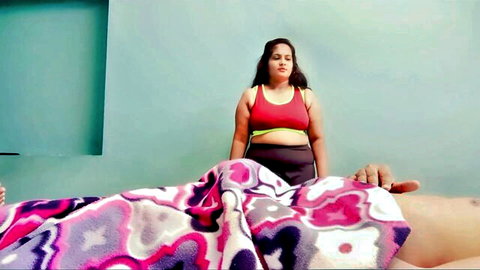 Curvy Indian model YourDisha in red sports bra and leggings over stepbro on bed