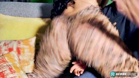 Curly-haired black woman in open fuzzy top during steamy morning embrace