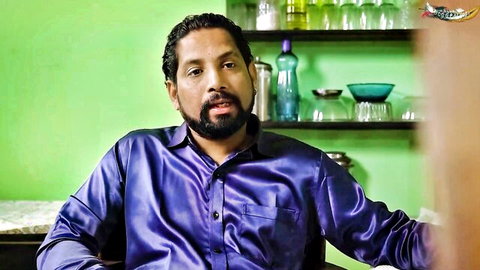 Bearded Desi man in shiny purple shirt, casual kitchen chat