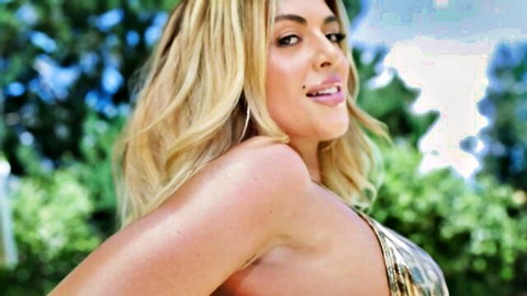Blonde Dani in gold bikini posing with phat ass outdoors