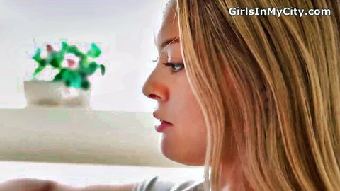 Busty blonde teen Amber Moore in seductive profile view welcoming home