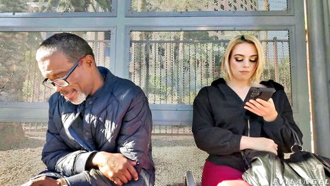 Sophia Burns blonde in hoodie and skirt at bus stop with older black man