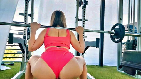 Brunette athletic babe deep squats in pink thong bottoms exposing juicy thick ass cheeks in gym