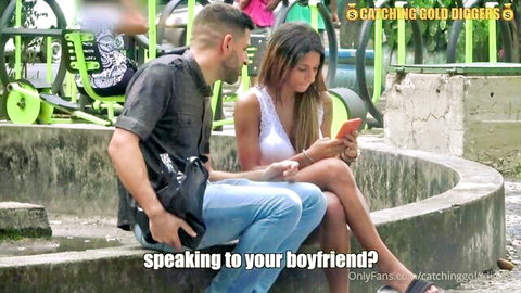 Sexy Latina with big tits and ass in tight shorts chats with boyfriend on phone while cuddling guy outdoors