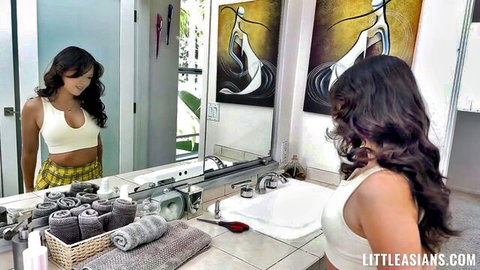 Lulu Chu in white tank top and plaid skirt, sexy bathroom mirror pose