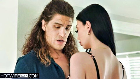 Long-haired stud embraces sexy brunette babe in black chain lingerie from behind