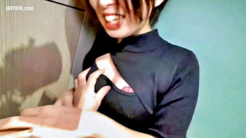 Fierce Asian woman pulls open black collared top exposing deep cleavage and tits