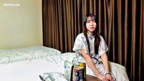 Young Asian babe exposing perky bare tits in open robe on bed
