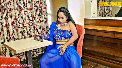Desi Indian Bhabhi in blue saree posing seductively with phone