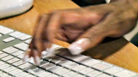 Black woman's hands typing on keyboard during online chat date
